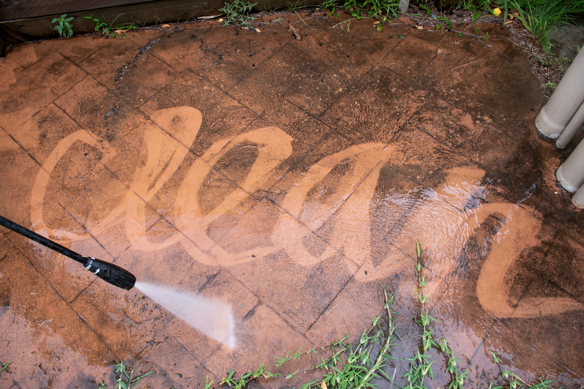 Cleaning backyard with pressure washer. Spring clean up